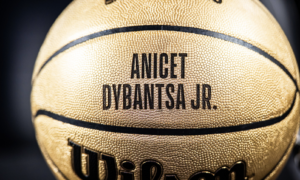 Golden basketball close-up with the name ANICET DYBANTSA JR. printed in bold black letters.