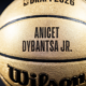 Golden basketball close-up with the name ANICET DYBANTSA JR. printed in bold black letters.