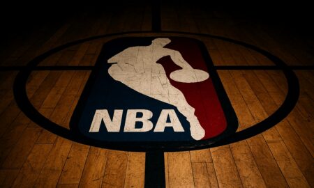 NBA logo on a wooden basketball court, viewed from above