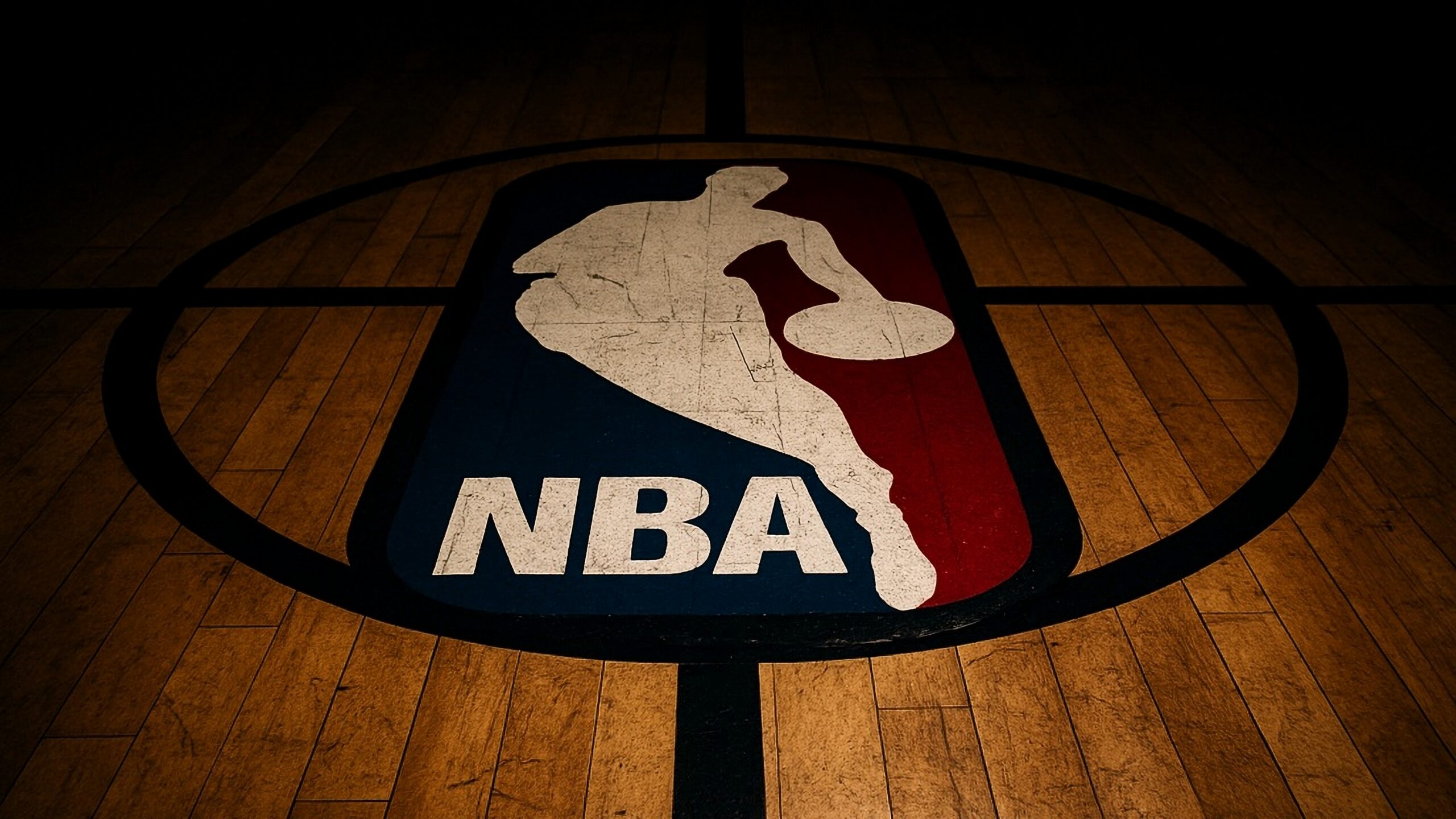 NBA logo on a wooden basketball court, viewed from above