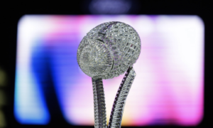Crystal-encrusted microphone on a stand with a multicolored blurred stage backdrop